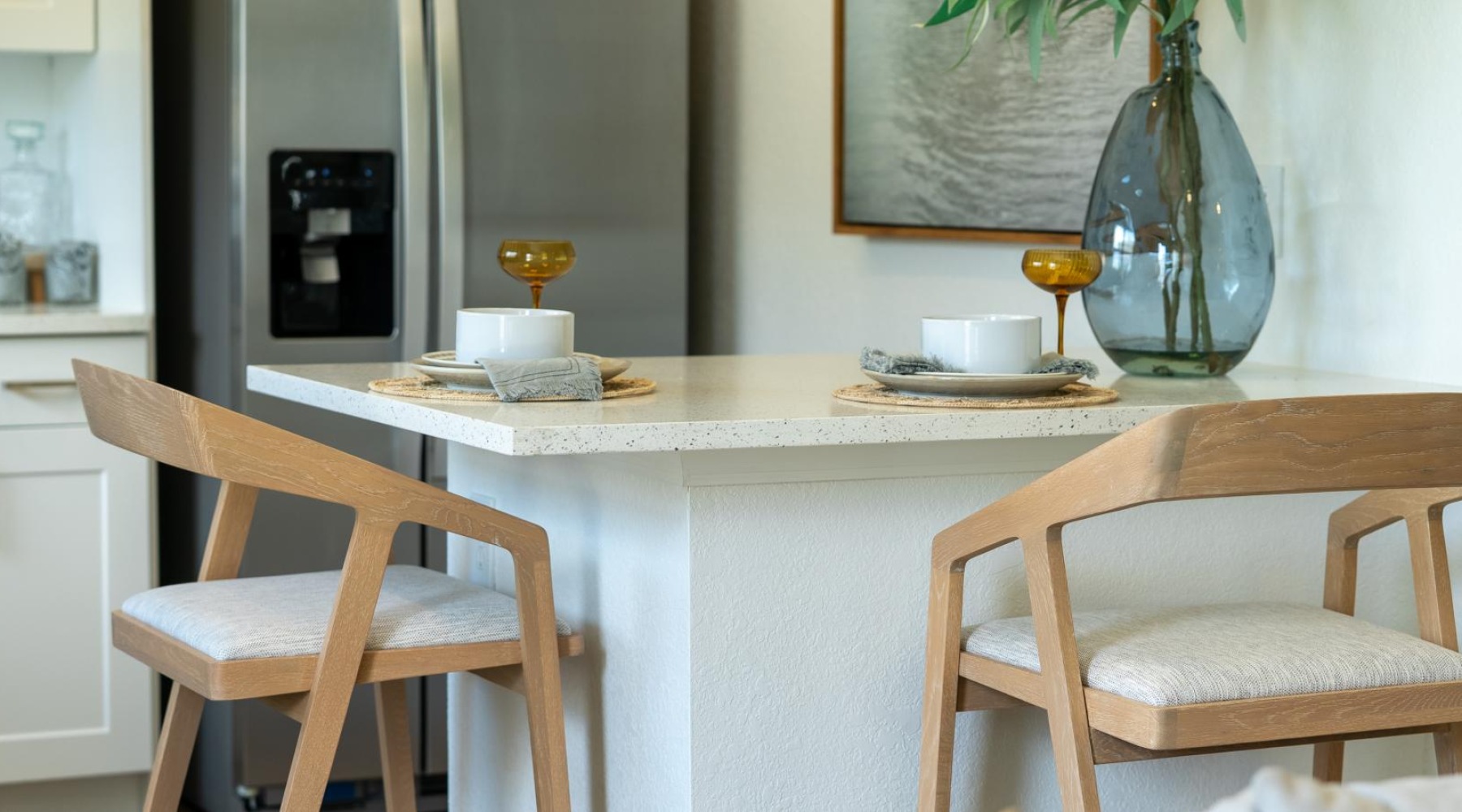 a dining table with chairs and a vase with food on it