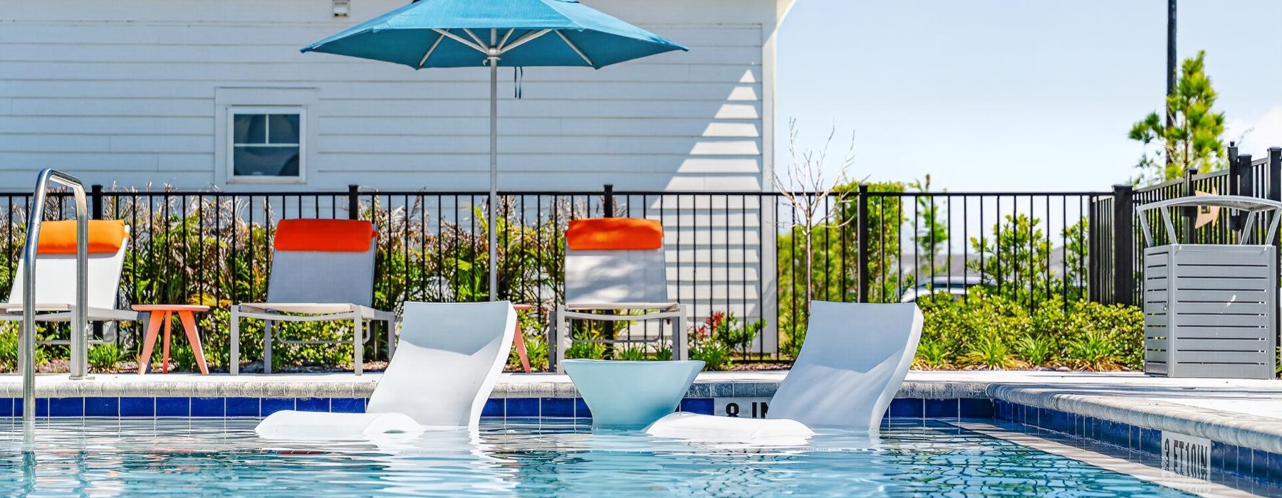 a pool with chairs and umbrella