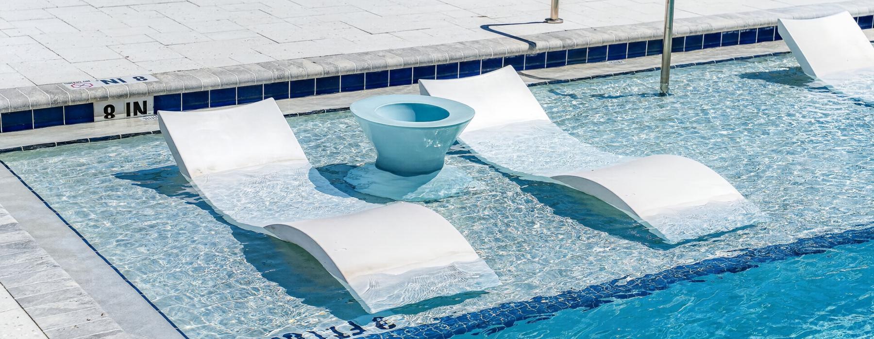 a pool with a blue water fountain