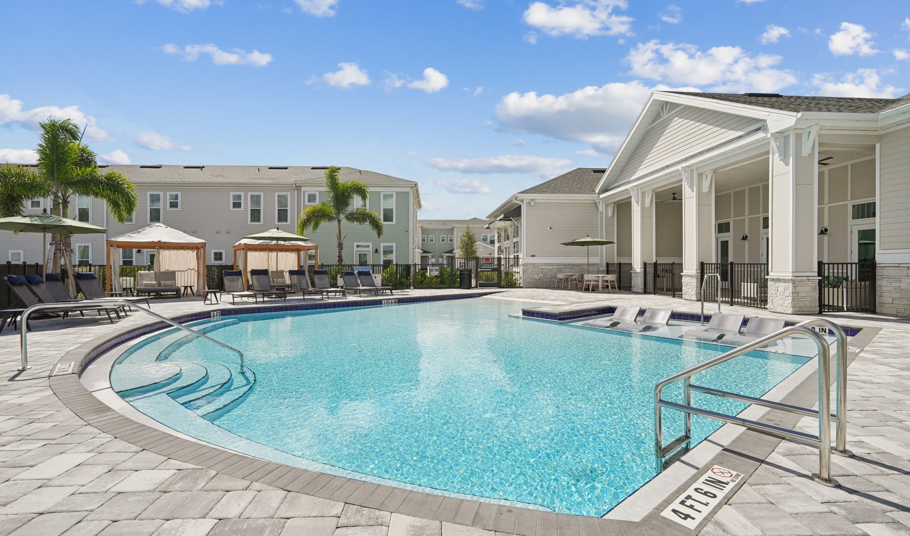 Photo of Pool with Loungers and Expansive Pool Deck