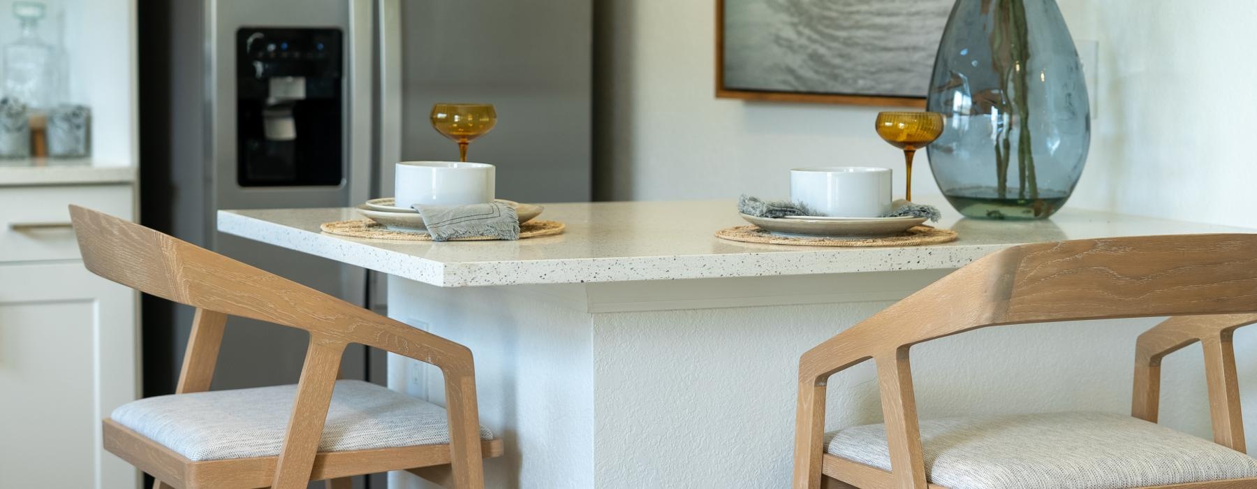 a dining table with chairs and a vase with food on it